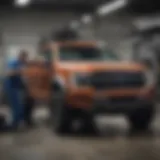 Service technicians performing maintenance on a Ford vehicle