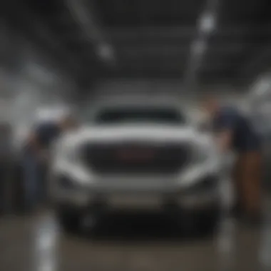 Service technicians working on a GMC vehicle in the service department